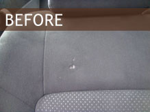 Hole in car seat before repair.